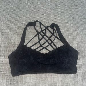 Never worn black lululemon sports bra, size 6!